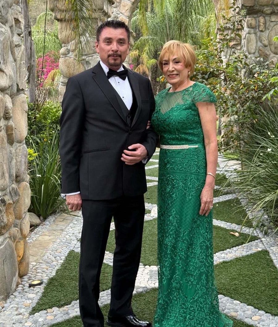 Carlos Moscot with Evangelina Garcia, Office Assistant, in a garden